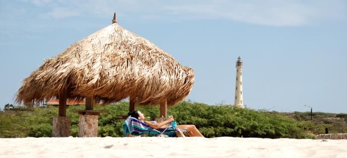 Arashi Beach - Woman is sunbathing - Lighthouse in the background