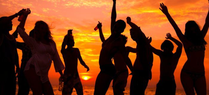 Young people dancing on the beach