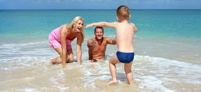 Happy family playing in the sea