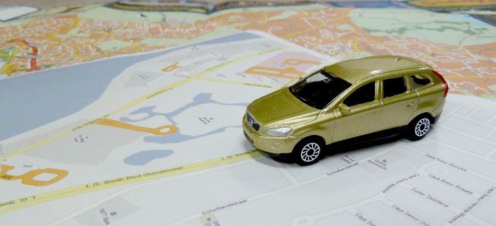 A toy placed on a road map of Aruba