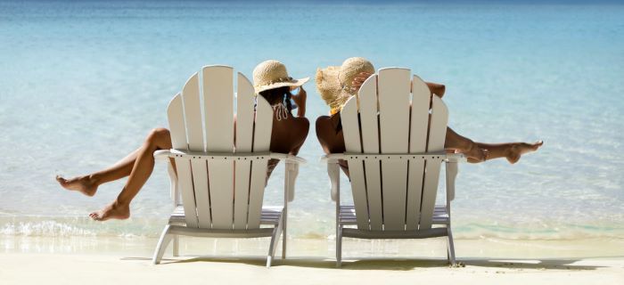 Woman sitting in chairs on the beach 
